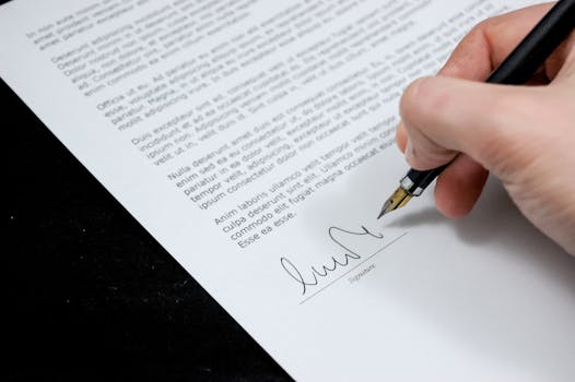 document-agreement-documents-sign-48195-48195 Close-up of a hand signing a formal document with a fountain pen, indicating agreement.
